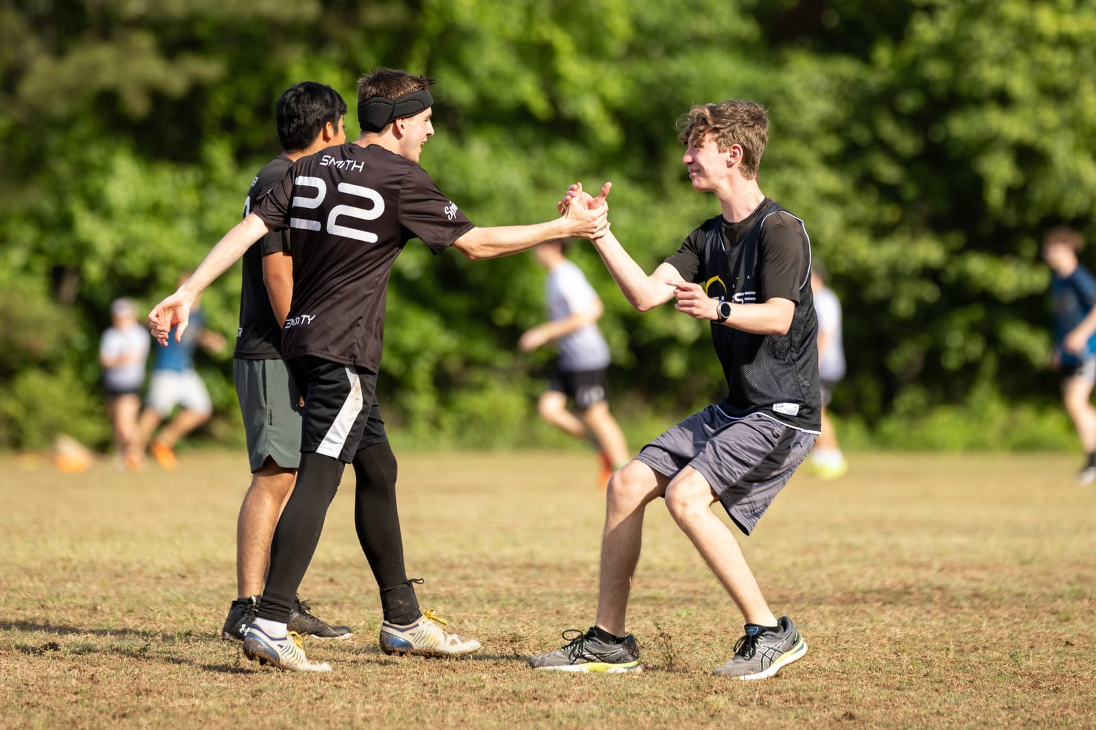 Two Eclipse players sharing a handshake after a point